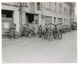 Infantrymen of 1st U.S. Army gather in Bastogne, Belgium, to regroup after being cut away from their regiment by Germans in the enemy drive in this area. 110 Regt, 28th LNE Div FUSA Bastogne, Belgium