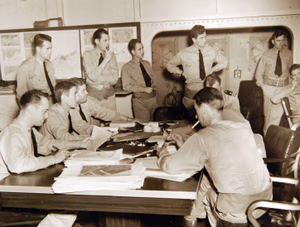 80-G-30210: Operation Torch, November 1942. Squadron commanders and intelligence officers onboard a warship (probably USS Ranger (CV-4) map out air plans for North African operations. Official U.S. Navy Photograph, now in the collections of the National Archives. (2017/06/06).