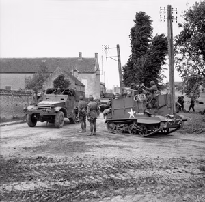 D-day - British Forces during the Invasion of Normandy 6 June 1944 A Universal Carrier with wading screens attached and half-tracks of 3rd Division passing through Hermanville-sur-Mer, 6 June 1944.