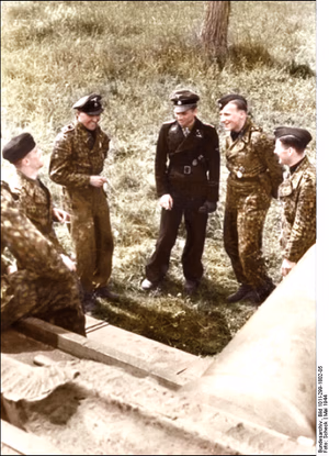 This is a retouched picture , which means that it has been digitally altered from its original version. Modifications: recolored . The original can be viewed here: Bundesarchiv Bild 101I-299-1802-05, Nordfrankreich, Michael Wittmann, Panzersoldaten.jpg : . Modifications made by Ruffneck88 . .mw-parser-output table.commons-file-information-table,.mw-parser-output .fileinfotpl-type-information,.mw-parser-output .fileinfotpl-type-artwork{border:1px solid var(--border-color-base,#a2a9b1);background-color:var(--background-color-interactive-subtle,#f8f9fa);padding:5px;font-size:95%;border-spacing:2px;box-sizing:border-box;margin:0;width:100%;color:inherit}.mw-parser-output table.commons-file-information-table>tbody>tr,.mw-parser-output .fileinfotpl-type-information>tbody>tr,.mw-parser-output .fileinfotpl-type-artwork>tbody>tr{vertical-align:top}.mw-parser-output table.commons-file-information-table>tbody>tr>td,.mw-parser-output table.commons-file-information-table>tbody>tr>th,.mw-parser-output .fileinfotpl-type-information>tbody>tr>td,.mw-parser-output .fileinfotpl-type-information>tbody>tr>th,.mw-parser-output .fileinfotpl-type-artwork>tbody>tr>td,.mw-parser-output .fileinfotpl-type-artwork>tbody>tr>th{padding:4px}.mw-parser-output .fileinfo-paramfield{background:#ccf;text-align:right;padding-right:0.4em;width:15%;font-weight:bold;color:inherit}.mw-parser-output .commons-file-information-table+table.commons-file-information-table,.mw-parser-output .commons-file-information-table+div.commons-file-information-table>table{border-top:0;padding-top:0;margin-top:-8px}@media only screen and (max-width:719px){.mw-parser-output table.commons-file-information-table,.mw-parser-output .commons-file-information-table .fileinfotpl-type-information,.mw-parser-output .commons-file-information-table .fileinfotpl-type-artwork{border-spacing:0;padding:0;word-break:break-word;width:100%!important}.mw-parser-output .commons-file-information-table>tbody,.mw-parser-output .fileinfotpl-type-information>tbody,.mw-parser-output .fileinfotpl-type-artwork>tbody{display:block}.mw-parser-output .commons-file-information-table>tbody>tr>td,.mw-parser-output .commons-file-information-table>tbody>tr>th,.mw-parser-output .fileinfotpl-type-information>tbody>tr>td,.mw-parser-output .fileinfotpl-type-information>tbody>tr>th,.mw-parser-output .fileinfotpl-type-artwork>tbody>tr>td,.mw-parser-output .fileinfotpl-type-artwork>tbody>tr>th{padding:0.2em 0.4em;text-align:left;text-align:start}.mw-parser-output .commons-file-information-table>tbody>tr,.mw-parser-output .fileinfotpl-type-information>tbody>tr,.mw-parser-output .fileinfotpl-type-artwork>tbody>tr{display:flex;flex-direction:column}.mw-parser-output .commons-file-information-table+table.commons-file-information-table,.mw-parser-output .commons-file-information-table+div.commons-file-information-table>table{margin-top:-1px}.mw-parser-output table .fileinfo-paramfield{box-sizing:border-box;flex:1 0 100%;width:100%}}.mw-parser-output table.commons-file-information-table,.mw-parser-output .fileinfotpl-type-information,.mw-parser-output .fileinfotpl-type-artwork,.mw-parser-output .fileinfo-paramfield{color:var(--color-base,#202122)}html.skin-theme-clientpref-night .mw-parser-output .fileinfo-paramfield{background:#2a2a5c;color:white}html.skin-theme-clientpref-night .mw-parser-output .fileinfotpl-type-artwork tbody>tr>th[style*="#ccf"]{background-color:#2a2a5c!important;color:white}@media screen and (prefers-color-scheme:dark){html.skin-theme-clientpref-os .mw-parser-output .fileinfo-paramfield{background:#2a2a5c;color:white}html.skin-theme-clientpref-os .mw-parser-output .fileinfotpl-type-artwork tbody>tr>th[style*="#ccf"]{background-color:#2a2a5c!important;color:white}} Nordfrankreich, Michael Wittmann, Panzersoldaten ( ) Photographer Scheck Archive description InfoField Description provided by the archive when the original description is incomplete or wrong. You can help by reporting errors and typos at Commons:Bundesarchiv/Error reports . Frankreich-Nord.- Obersturmführer Michael Wittmann mit Eichenlaub zum Ritterkreuz (verliehen am 30. Januar 1944) mit Panzersoldaten vor Panzer VI "Tiger I"; PK 698 Title Nordfrankreich, Michael Wittmann, Panzersoldaten Depicted people Wittmann, Michael : SS-Hauptsturmführer, Ritterkreuz, Waffen-SS, Deutschland ( GND 119260573 ) Depicted place Nordfrankreich Date May 1944 date QS:P571,+1944-05-00T00:00:00Z/10 Collection German Federal Archives Native name Das Bundesarchiv Parent institution Federal Government Commissioner for Culture and Media Location Koblenz (headquarters) Coordinates 50° 20′ 32.71″ N, 7° 34′ 21.22″ E Established 1946 Website www.bundesarchiv.de Authority file : Q685753 VIAF : 137346469 ISNI : 0000000405552728 LCCN : n92025526 NLA : 36455393 OSM : 1844909 WorldCat institution QS:P195,Q685753 Current location Propagandakompanien der Wehrmacht - Heer und Luftwaffe (Bild 101 I) Accession number Bild 101I-299-1802-05 Source This image was provided to Wikimedia Commons by the German Federal Archive (Deutsches Bundesarchiv) as part of a cooperation project . The German Federal Archive guarantees an authentic representation only using the originals (negative and/or positive), resp. the digitalization of the originals as provided by the Digital Image Archive .