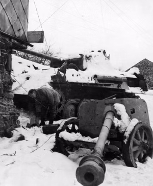 An abandoned German 7.5 cm-Pak 40 anti-tank gun and a Panzer V Panther near Stavelot, Belgium, circa in February 1945.