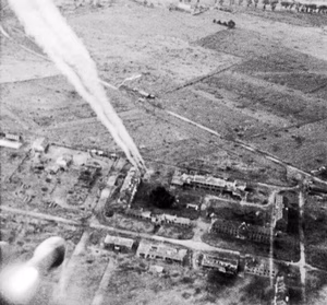 A rocket fired from a Typhoon of No 181 Squadron, Royal Air Force , on its way towards buildings at Carpiquet airfield during the battle for Normandy. The Canadian 3rd Division took Carpiquet to the west of Caen on 4 July.