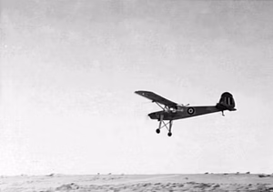 A captured Fieseler Fi 156 C-3/Trop Storch in flight near El Alamein, Egypt. Royal Air Force Air Vice Marshal Harry Broadhurst, Air Officer Commanding the Desert Air Force, acquired a captured German communications aircraft in North Africa, had it painted in British markings and used it for touring the units under his command. He continued flying the Storch while commanding the 2nd Tactical Air Force in North-West Europe.