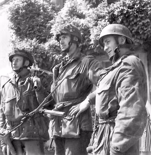Men of D Company Oxfordshire and Buckinghamshire Light Infantry after capturing " Pegasus Bridge " (the Caen Canal Bridge at Benouville ), France. Original wartime caption : Some of the first British Glider troops to set foot on French soil on "D" Day at 12.20 a.m. They are left to right: Private Frank Gardner of Blackfen Road, Sidcup, Kent; Captain Brian Priday of Haslebourne Stanstead Road, Caterham, Surrey; L/Corporal B.H.Lambley of 69 Hornsey Park Road, London. These men landed from gliders at 12.20 a.m. on "D" Day. They also appear in B 5585 above.