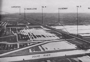 View of the Carentan causeway from the north, with bridges 3 and 4 marking waterways crossed by the causeway, and the town of Carentan in the background.