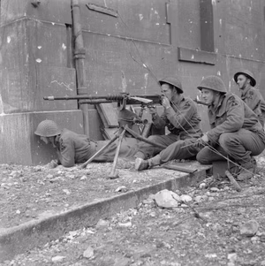 The British Army in Normandy 1944 Troops of 1 Kings Own Scottish Borderers (KOSB), 9th Brigade, 3rd Infantry Division, firing a captured Hotchkiss machine gun during street fighting in Caen, 10 July 1944.