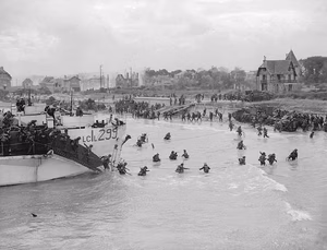 View looking east along 'Nan White' Beach, showing personnel of the 9th Canadian Infantry Brigade landing from LCI(L) 299 of the 2nd Canadian (262nd RN) Flotilla on D-Day