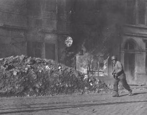 US Army rifleman in a burning Aachen.