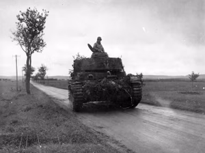 A captured German Panzer IV driven by U.S. soldiers at Grandvillars, Territoire de Belfort, France, 18 October 1944.