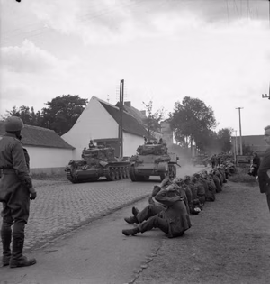 The British Army in North-west Europe 1944-45 Cromwell and Stuart tanks of Guards Armoured Division passing German POWs during the advance to Brussels, 3 September 1944.