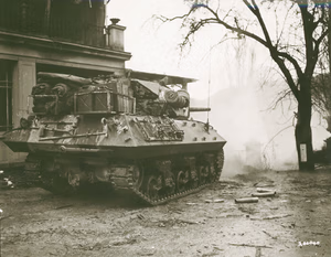An M10 tank destroyer from the 803rd Tank Destroyer Battalion firing on a German pillbox on the other side of the Sauer River near Echternach, Luxembourg, supporting an advance by the 5th Infantry Division's 11th Infantry Regiment. Signal Corps Photo #200040