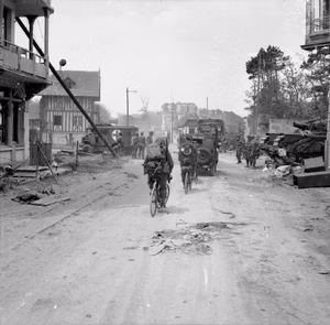 D-day - British Forces during the Invasion of Normandy 6 June 1944 Vehicles and infantry on bicycles of British 3rd Division in La Brèche d'Hermanville, as they move inland from Sword Beach, 6 June 1944. A Churchill AVRE can be seen on the right.