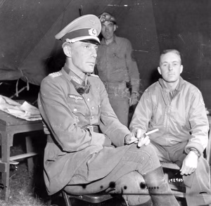 Lt. General Ellfeldt was captured while trying to pull out of the Allies' pincer movement. Questioning him is Lt. Col. James J. Gaynor, G-2, 5th Corps. Actual capture took place at St. Lambert-Sur-Dives, France. 21 August, 1944. Photographer: Poinsett.