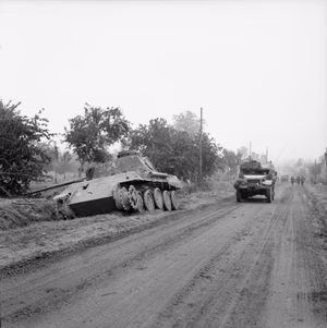 The British Army in Normandy 1944 A half-track passes a knocked-out German Panther tank on a road near Tourville, 16 July 1944.