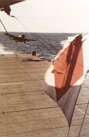 A U.S. Navy Grumman F6F-5 Hellcat of Observation Fighting Squadron 1 (VOF-1) is waved off during a landing attempt on the escort carrier USS Tulagi (CVE-72), after an air-support mission over Southern France on "Operation Dragoon" D-Day, 15 August 1944.