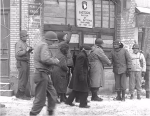 Scope and content: Original caption: Generals of the 101st Airborne Division review the 101st Div. in the town of Bastogne, Belgium. They are in front of "The Bastion of the Battered Bastards of the 101st." 1/18/45. Bastogne, Belgium.
