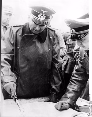 For documentary purposes the German Federal Archive often retained the original image captions , which may be erroneous, biased, obsolete or politically extreme . Generalfeldmarschall von Kluge, der neu ernannte Oberbefehlshaber West, befand sich in den letzten Tagen auf einer Besichtigungsfahrt an der Kanalküste. Er besuchte die dort eingesetzten Divisionen und informiert sich über den Stand der Verteidigungs- und Abwehrmaßnahmen im Falle einer erneuten Landung des Feindes. Am Kartentisch unterrichtet der Generalfeldmarschall den Kommandierenden General eines Armee-Korps, General der Panzertruppen Kuntzen. PK-Aufn.-Kriegsber.: Scheck, 21.7.1944