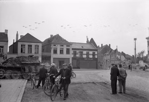 The British Army in North-west Europe 1944-45 American C-47 aircraft flying over Gheel in Belgium on their way to Holland for Operation 'Market-Garden', 17 September 1944. In the foreground is a knocked-out German Jagdpanther tank destroyer.