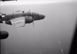 Royal Air Force- 2nd Tactical Air Force, 1943-1945. North American Mitchell Mk IIs of No. 226 Squadron RAF based at Hartford Bridge, Hampshire, fly over an Allied convoy bound for France, while on their way to bomb the 21st Panzer Division, dispersed in the Foret de Grimbosq south of Caen.