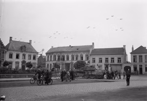 The British Army in North-west Europe 1944-45 American C-47 aircraft flying over Gheel in Belgium on their way to Holland for Operation 'Market-Garden', 17 September 1944. In the foreground is a knocked-out German Jagdpanther tank destroyer.